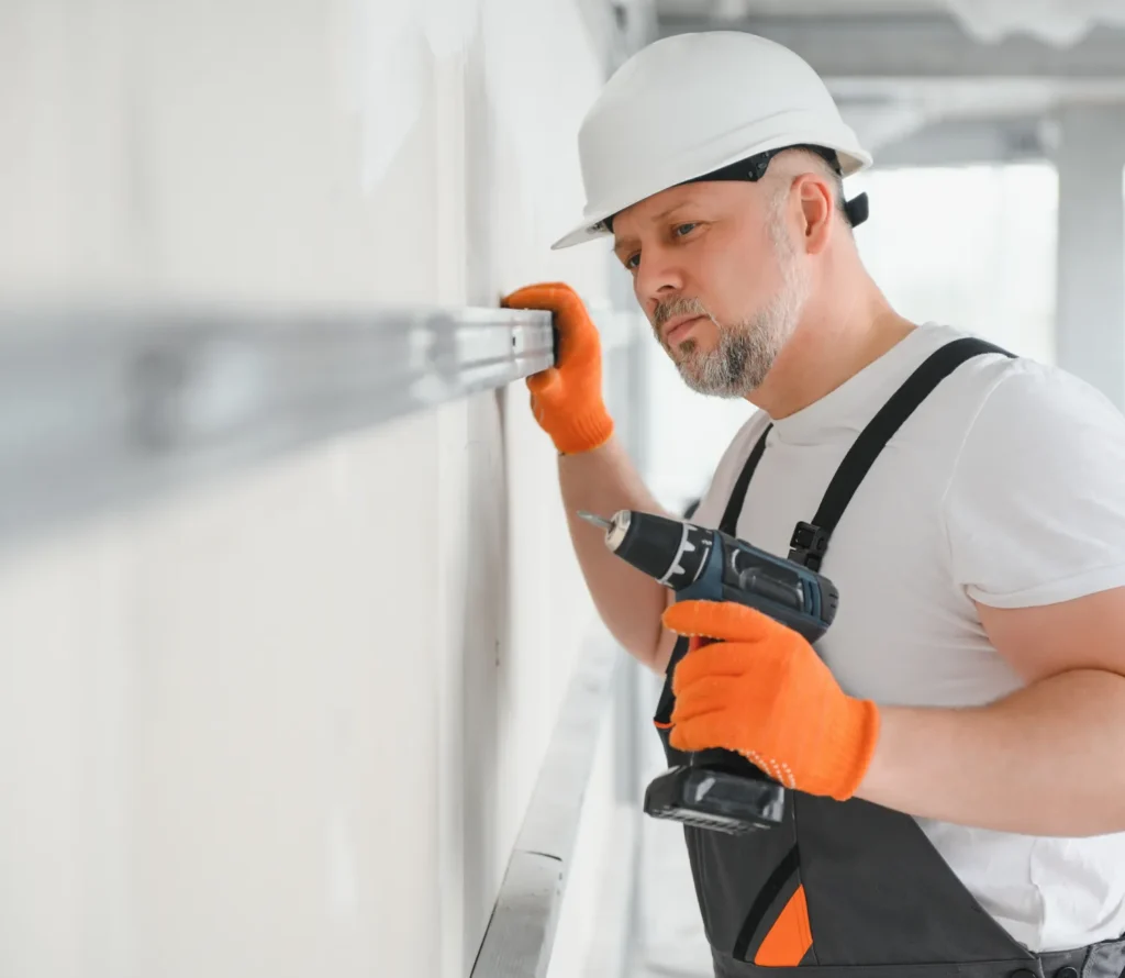 Technician drilling during equipment installation