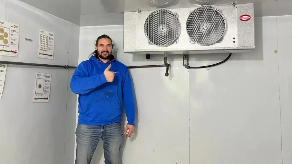 Cold Fuel technician giving a thumbs up in a walk-in freezer
